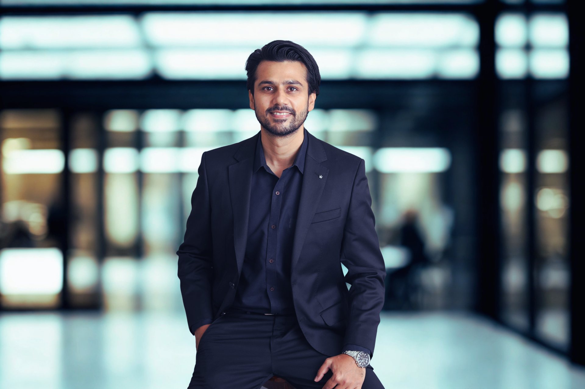 Varun in a modern office lobby, ready for the next programme.